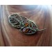 Brass feather brooch with amber