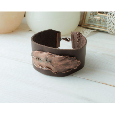 Wide leather bracelet with copper feather